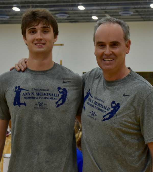 A McDonald sibling with his son at the basketball tournament