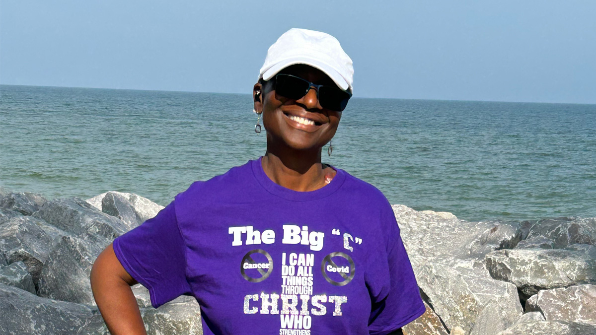 Yvonne smiling in front of the ocean