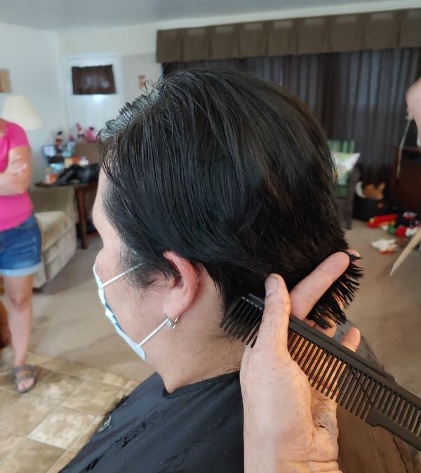 Lisa Walker gets her dark hair cut very short in preparation for chemotherapy.