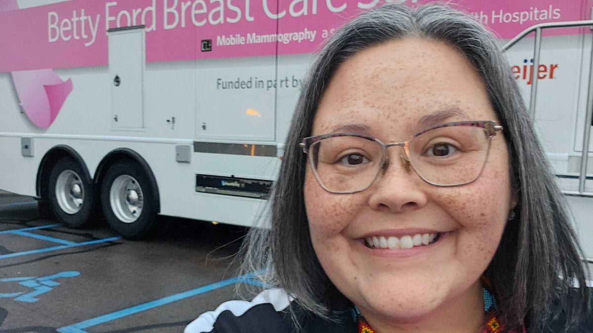 Lisa Walker stands proudly in front of the mobile mammography unit which is part of a program she led to help Native American women have greater access to care.