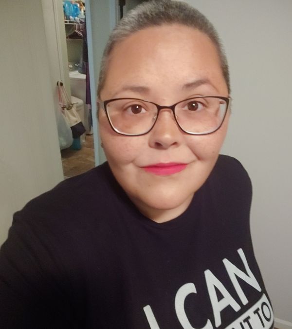 Wearing red lipstick, Lisa Walker shows off her closely cropped hair.