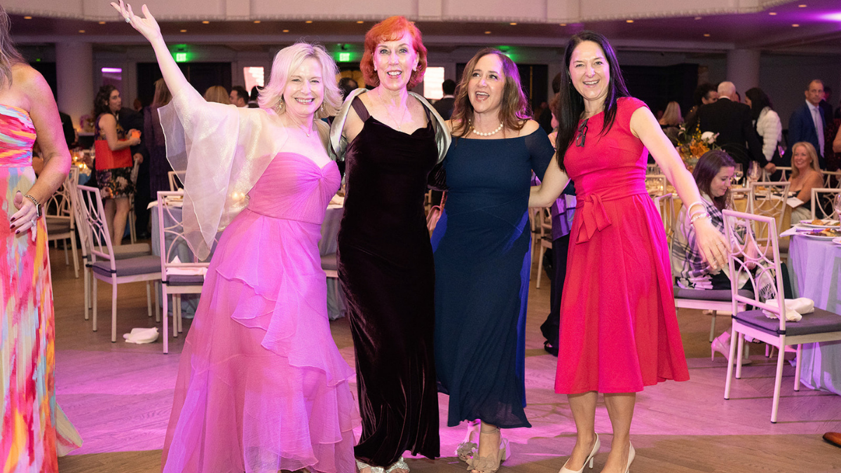 4 white women dressed up on the dance floor