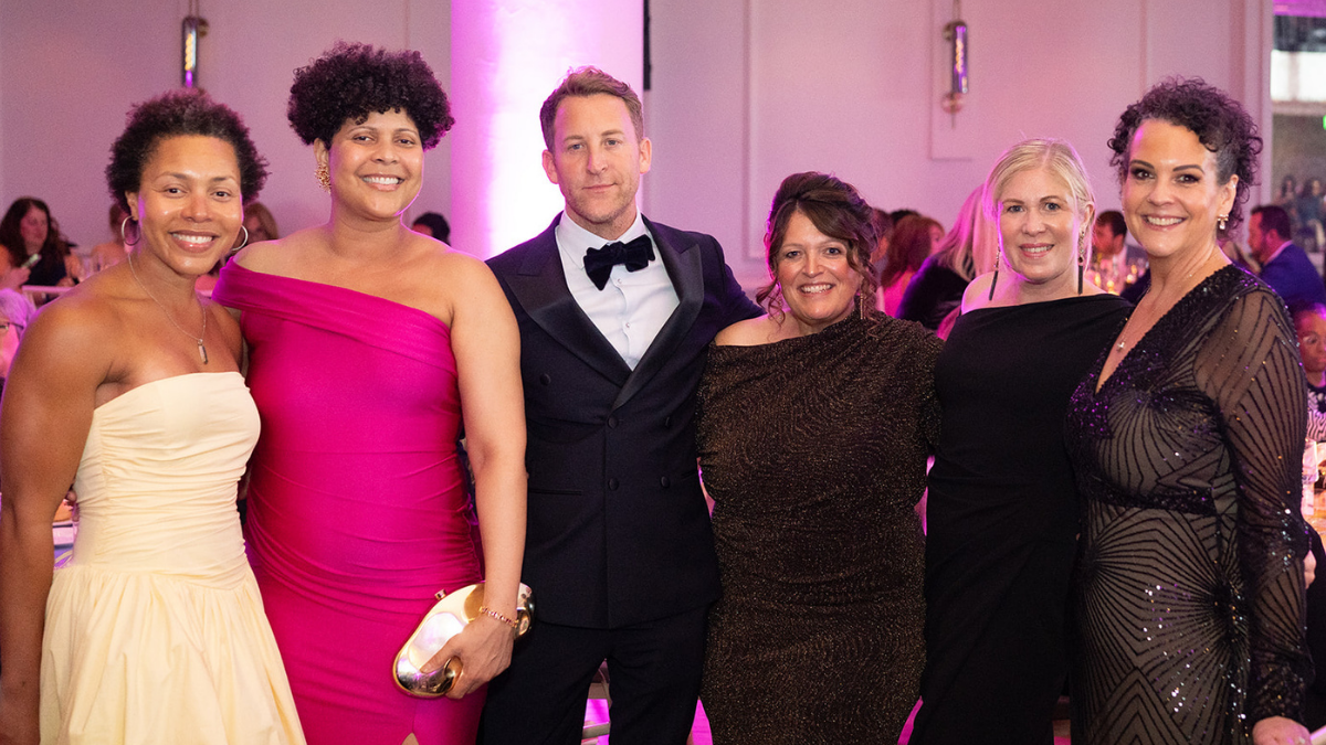 Richard Paxman smiling with some board members