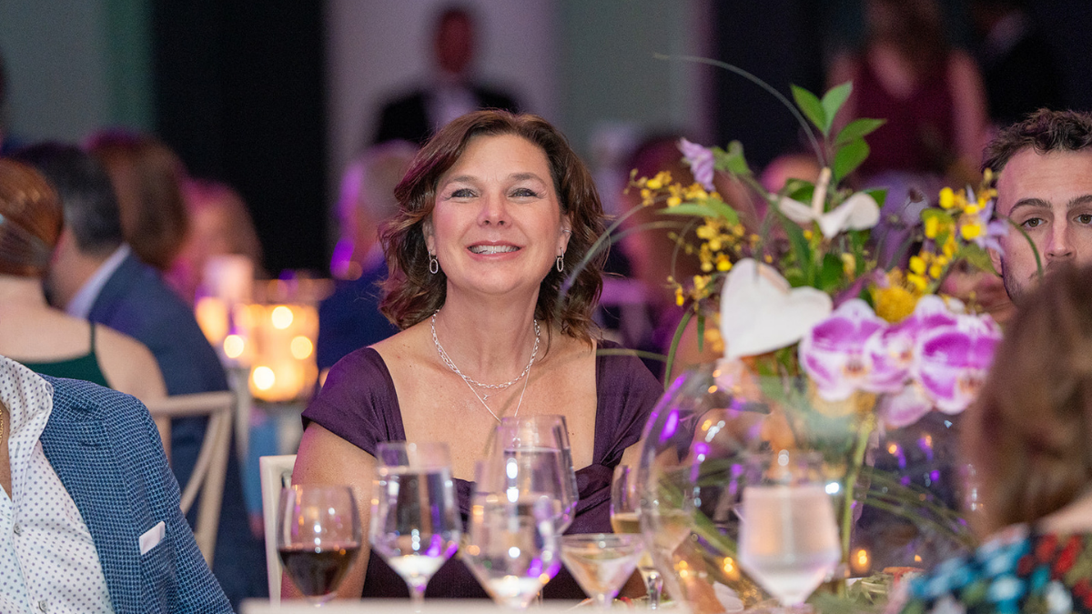 A white woman smiling at her table