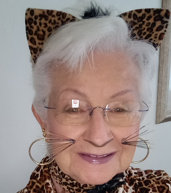 Myra smiling with cat ears and whiskers