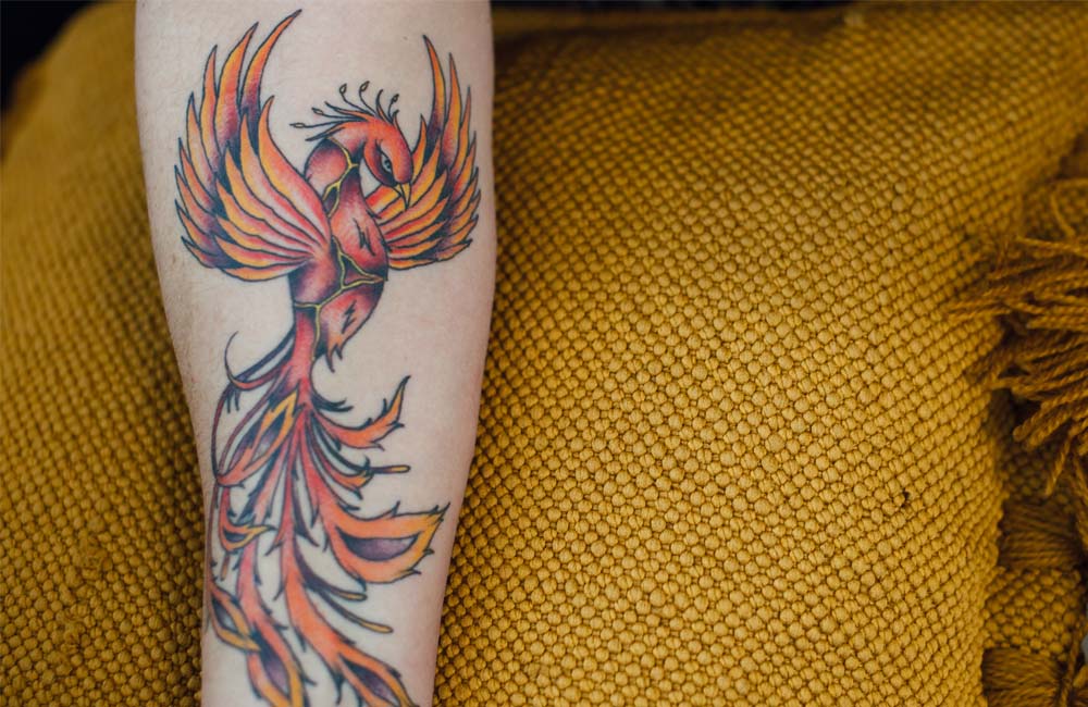 Forearm tattoo of a phoenix.