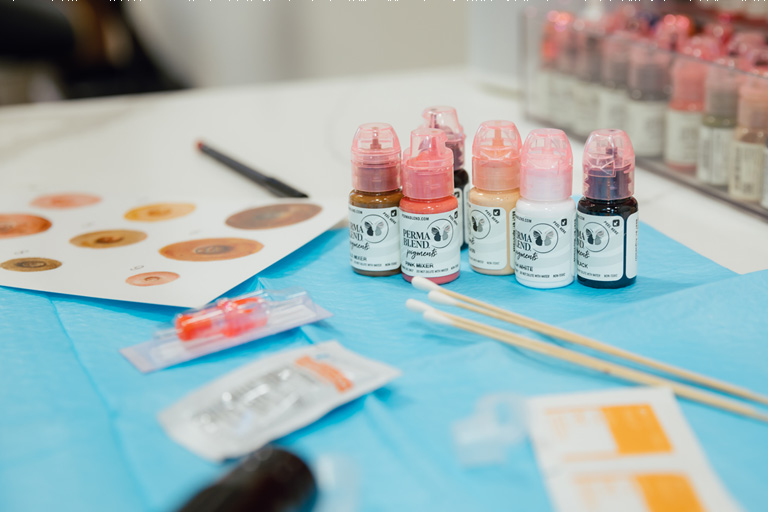 Display of tattoo inks and supplies to create 3D nipple tattoos.