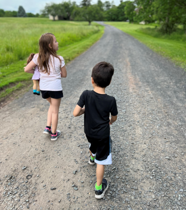 Jenny's two youngest children walking on a gravel path