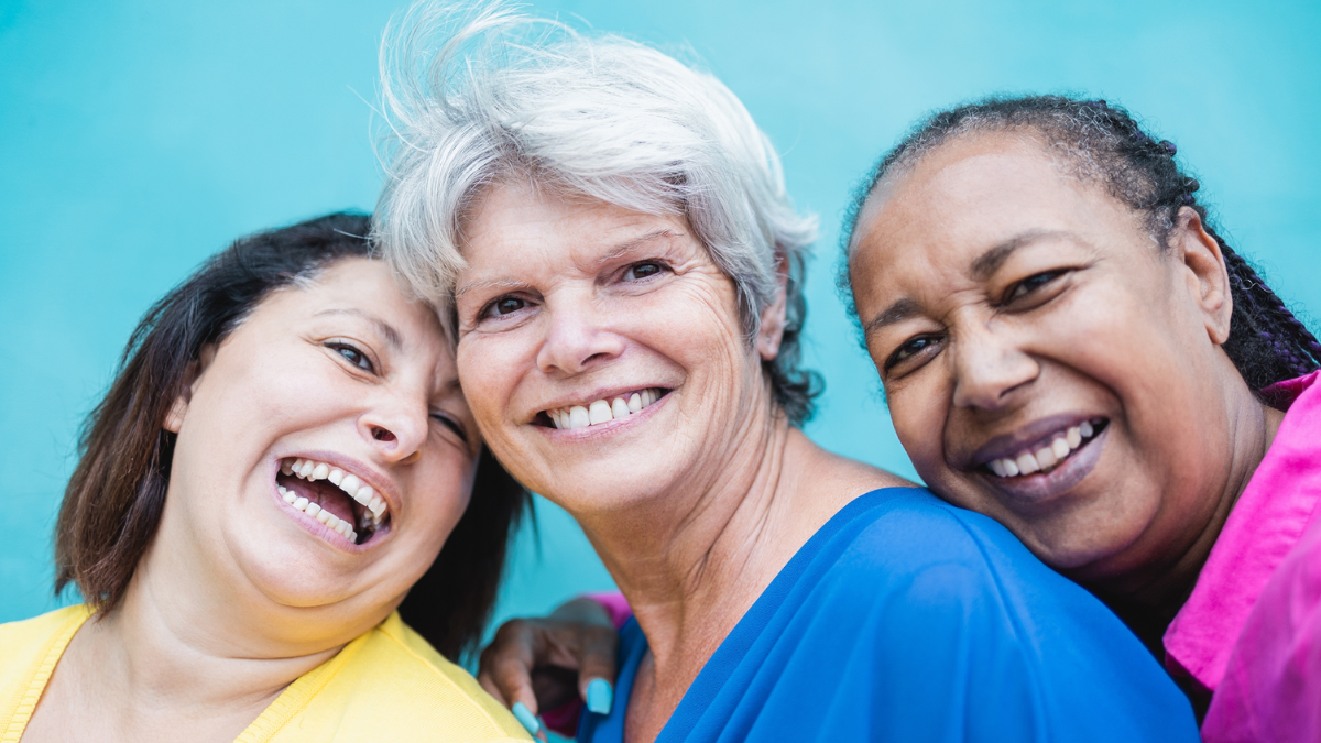 A diverse group of older women smiling