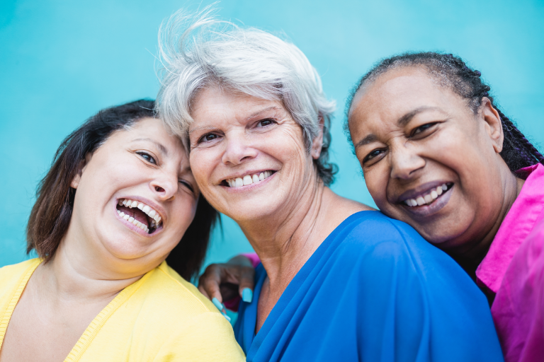 A diverse group of older women smiling