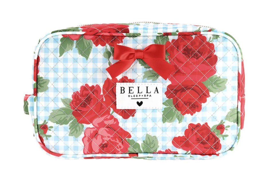 A travel makeup case with red roses on it