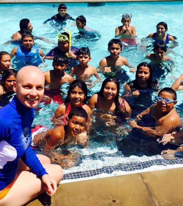 Szilva Gogh teaches scuba skills to children who are having fun in a pool.