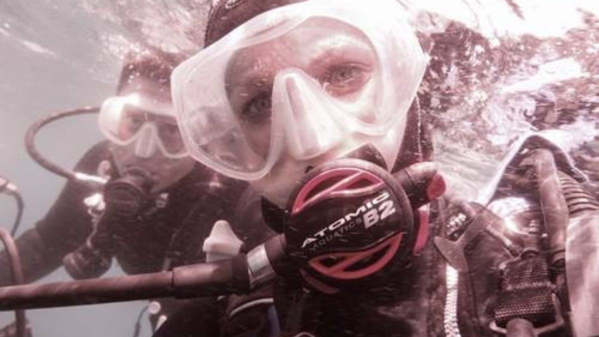 Szilvia Gogh scuba dives under the water.