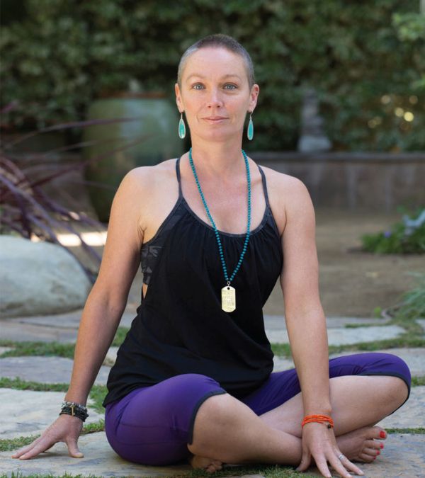 Szilva Gogh does yoga in a serene outdoor setting.
