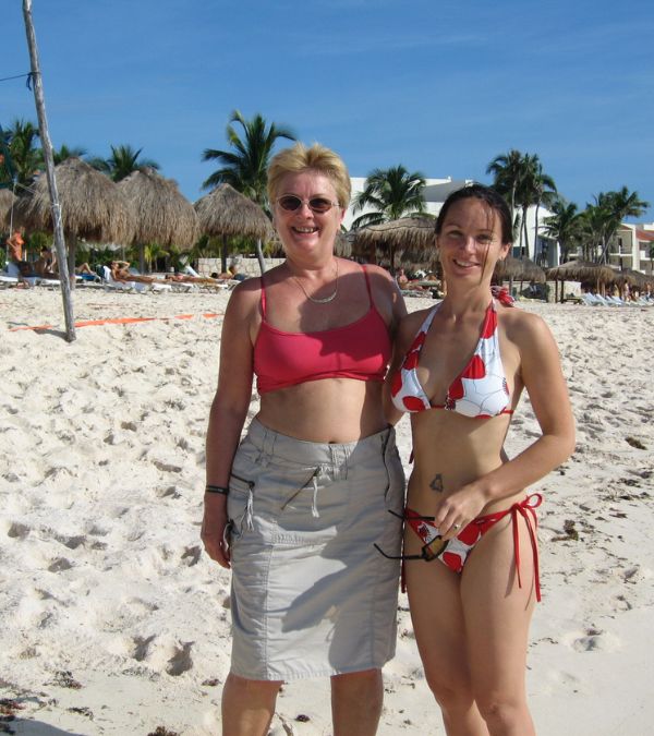 Szilvia Gogh, a young adult, stands with her mother, both clearly in their happy place, on the beach.