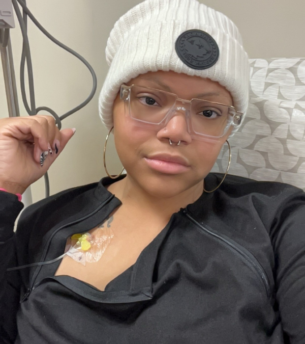 Tiana Russell smiling in a selfie in her chemo chair