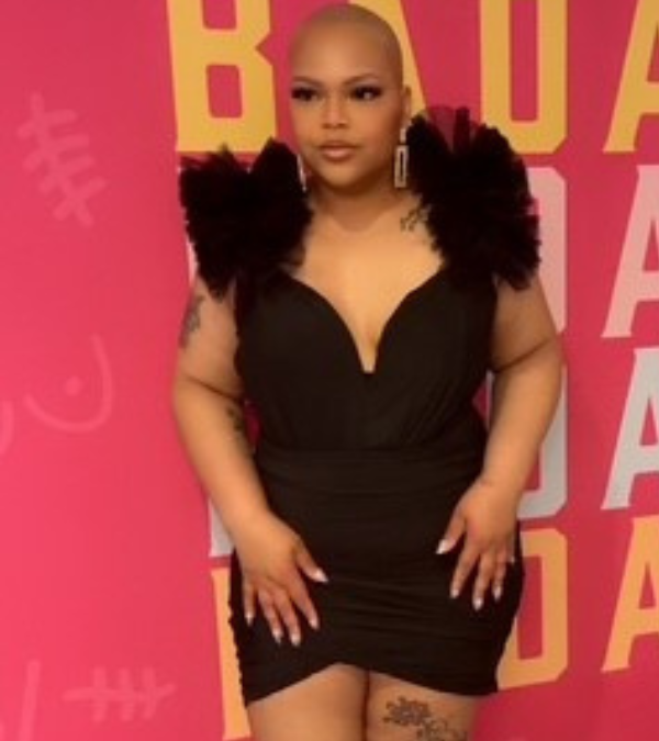 Tiana Russell smiling in a black dress