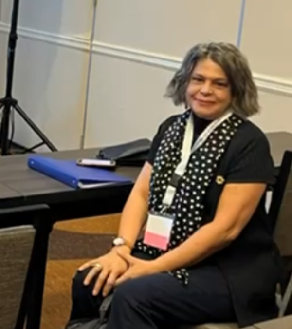 Betty Sanchez seated at an advocacy event.