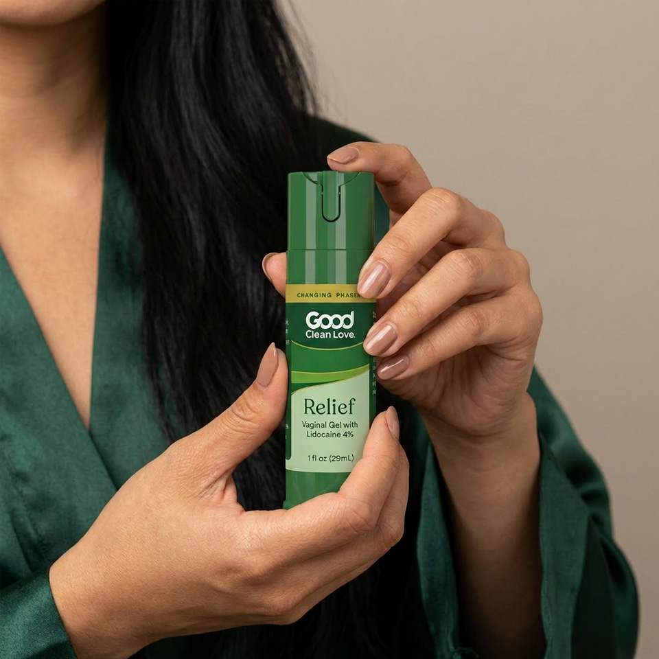 A woman holding a green spray bottle of vaginal lidocaine 4%