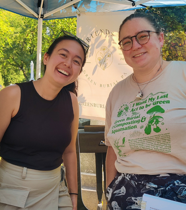 Death doula Isabel Knight poses with a colleague at a community event for Friends of Green Burial.