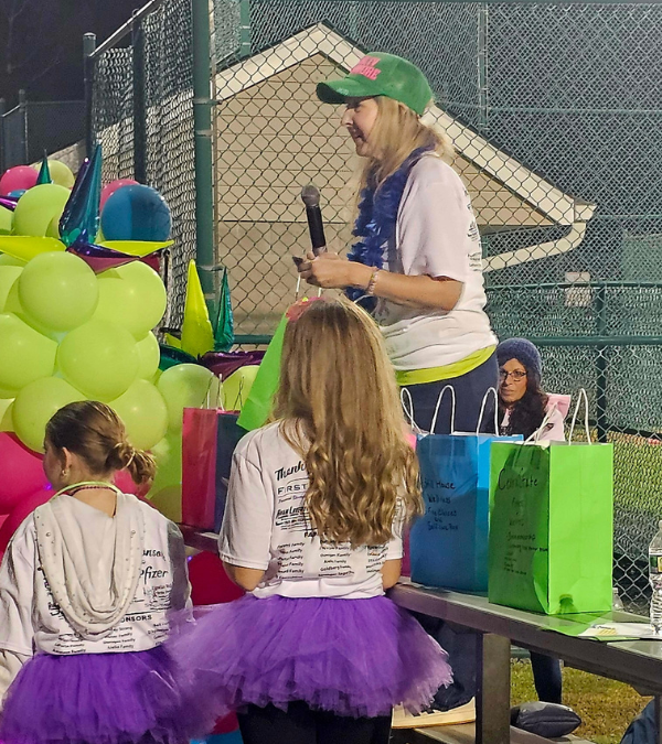 Jessica Fioretti addresses a group of children and adults at an advocacy event.