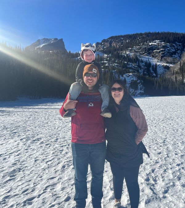 Kyla Wenger and her family huddle close on a snowy mountain path.