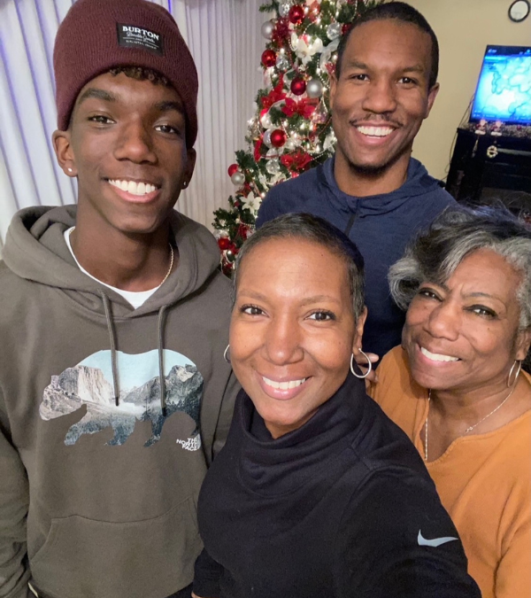 Stacey Kirksey and her family pose in front of their Christmas tree.