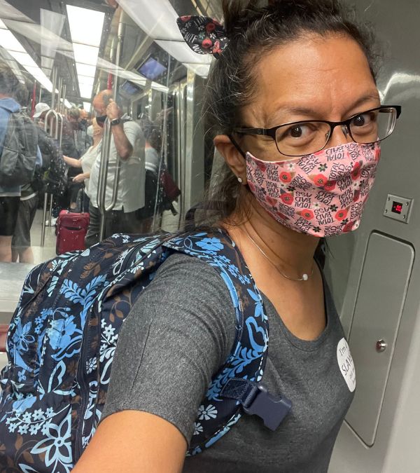 Tierrnee' Jefferis travels aboard a shuttle bus, mask on for protection.