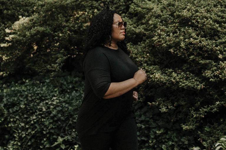 A Black woman jogging outside