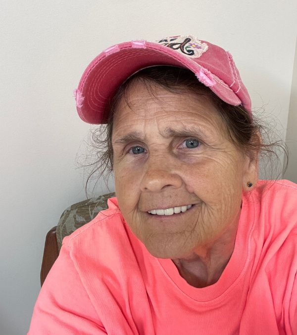 Sherry Lawson wears an easy smile and wears her pink baseball cap.
