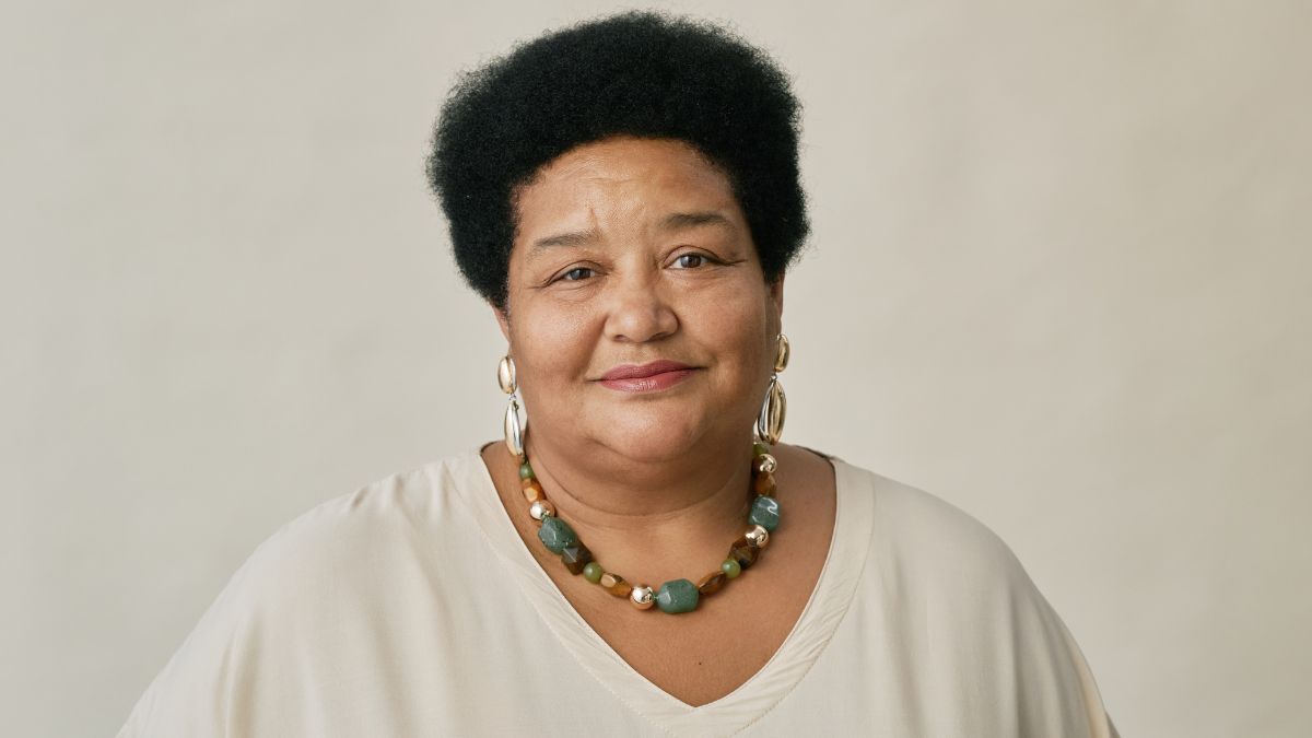 A Black woman with a half-smile