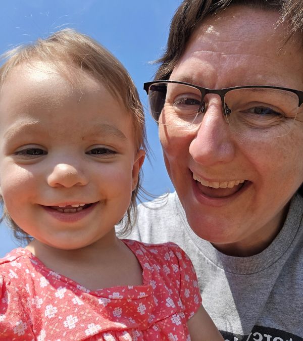 Ericka Toth, holds her granddaughter, who is a toddler, close. They both have huge smiles.