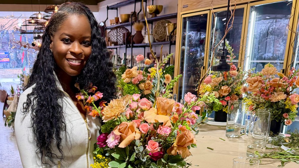 Nikki Taylor, MD, proudly displays a gorgeous flower arrangement she's made.
