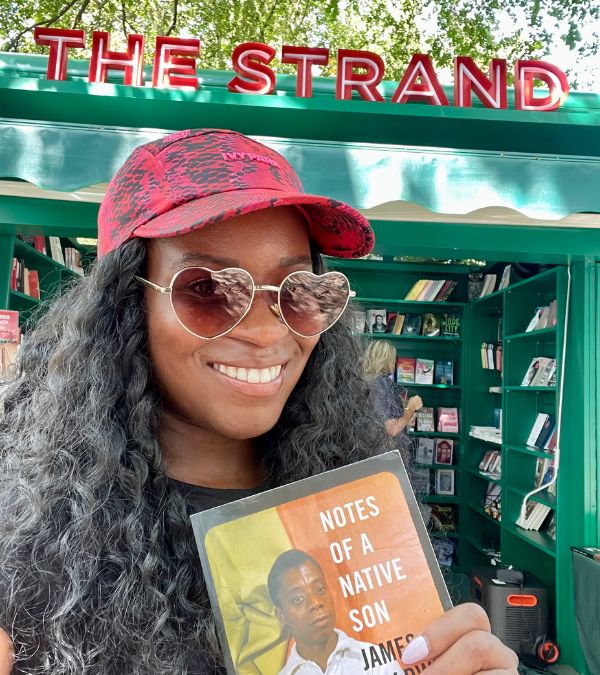 Nikki Taylor holds a book by James Baldwin as she shops at The Strand.