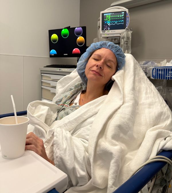 Kim Quick lies in her hospital bed after her mastectomy.