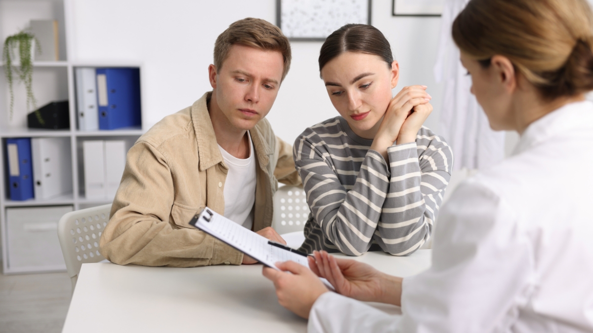 A young couple consults with a fertility specialist.