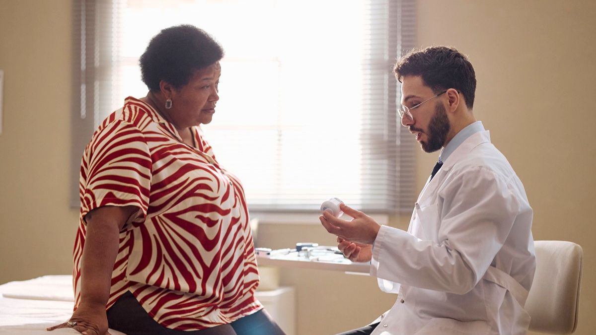 A Black woman and a male doctor in a conversation