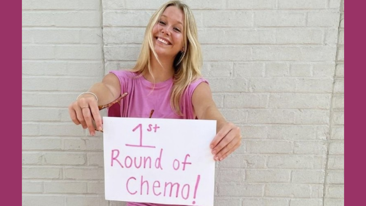 Actress Miranda McKeon from Netflix's Anne with an E holds up a handmade sign that says "1st round of chemo!"