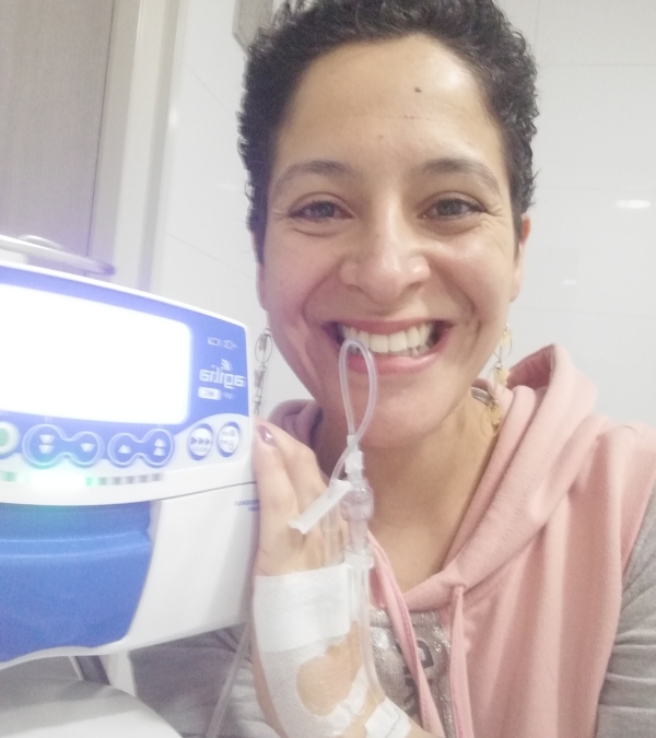 Gynna Quintero stands by her chemotheraphy infusion machine.