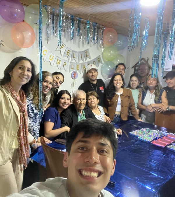 Gynna Quintero and her family of diverse ages gather at the table for a celebration.