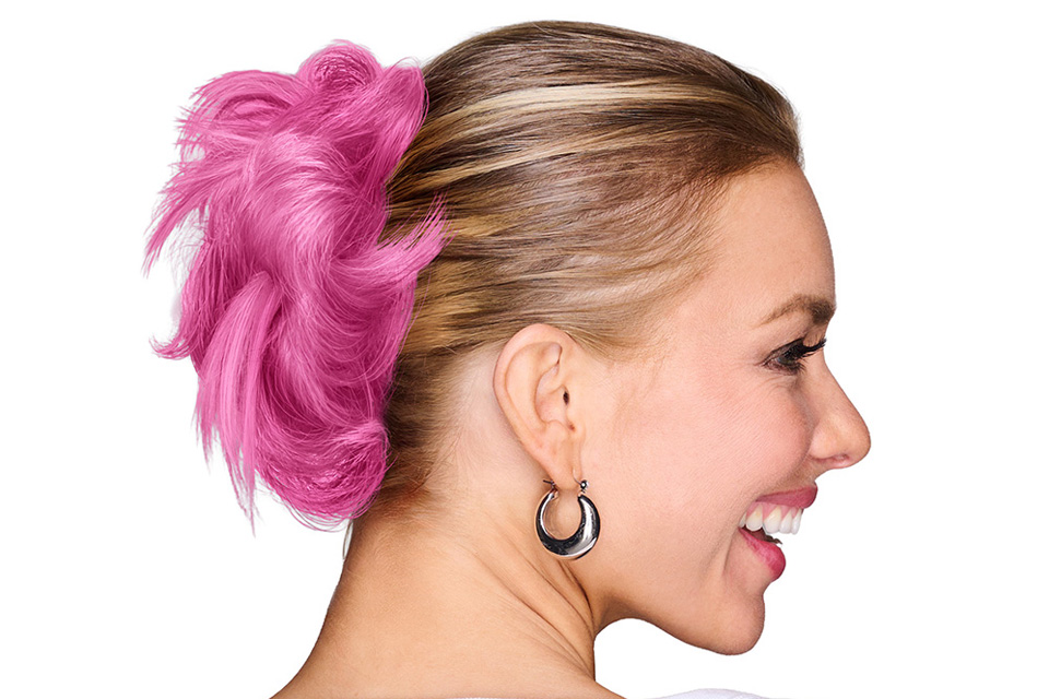 A white woman wearing a pink hair wrap