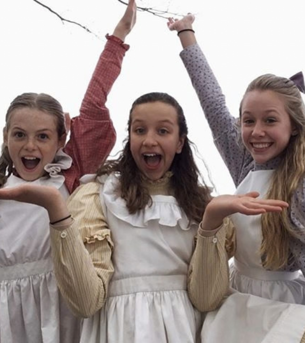Actress Miranda McKeon in costume on set with her co-stars from Netflix's Anne with an E.
