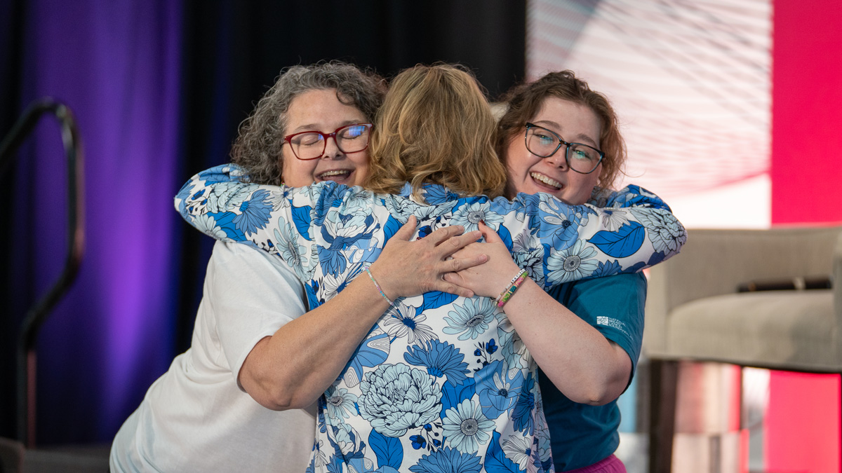 3 white woman hugging