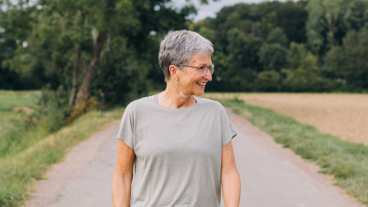 An older white woman walking outside