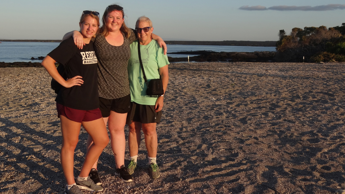 Lilly and Kathryn Bolen pose with their mom, Lauren, on the beach.
