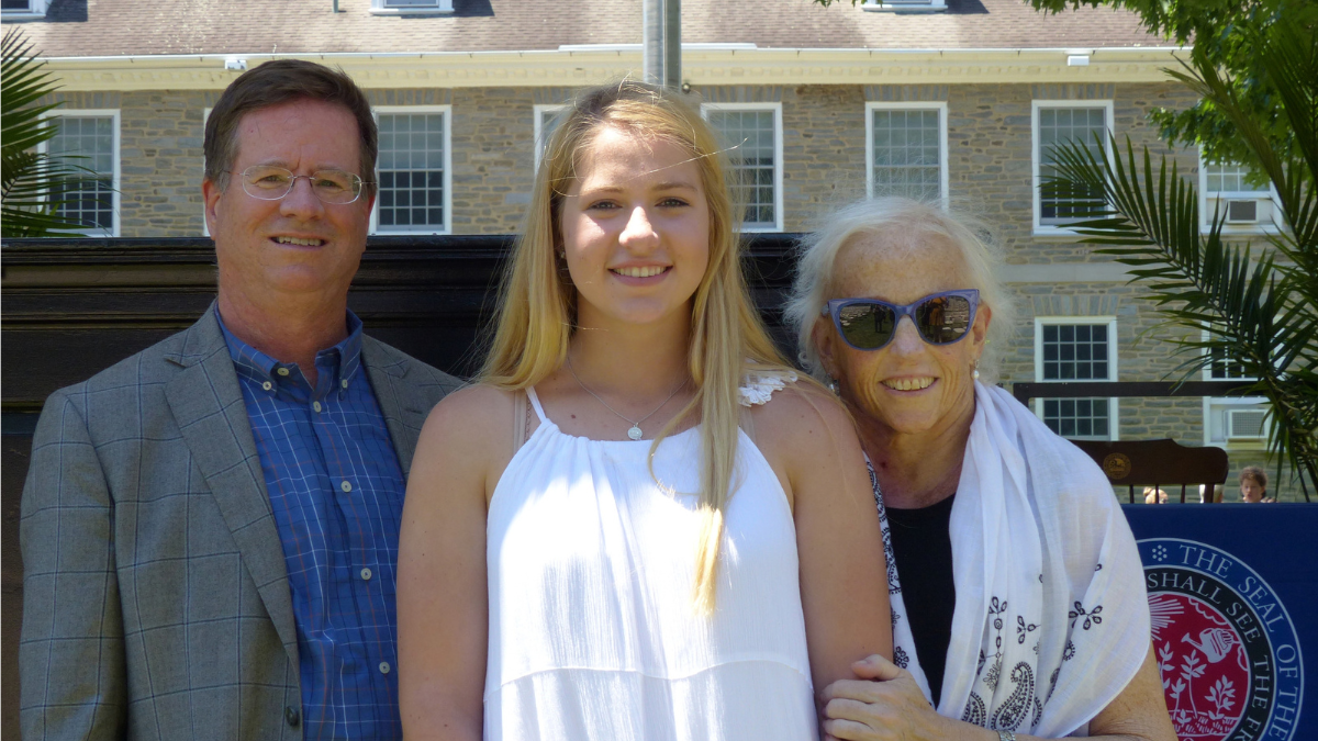 Lilly Bolen poses with her parents, Mike and Lauren, at her high school graduation.