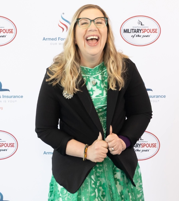 Meg Graves displays her joy at being awarded "Military Spouse of the Year" with her huge smile.