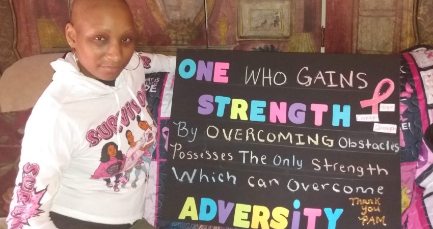 Kiana holding inspirational sign.